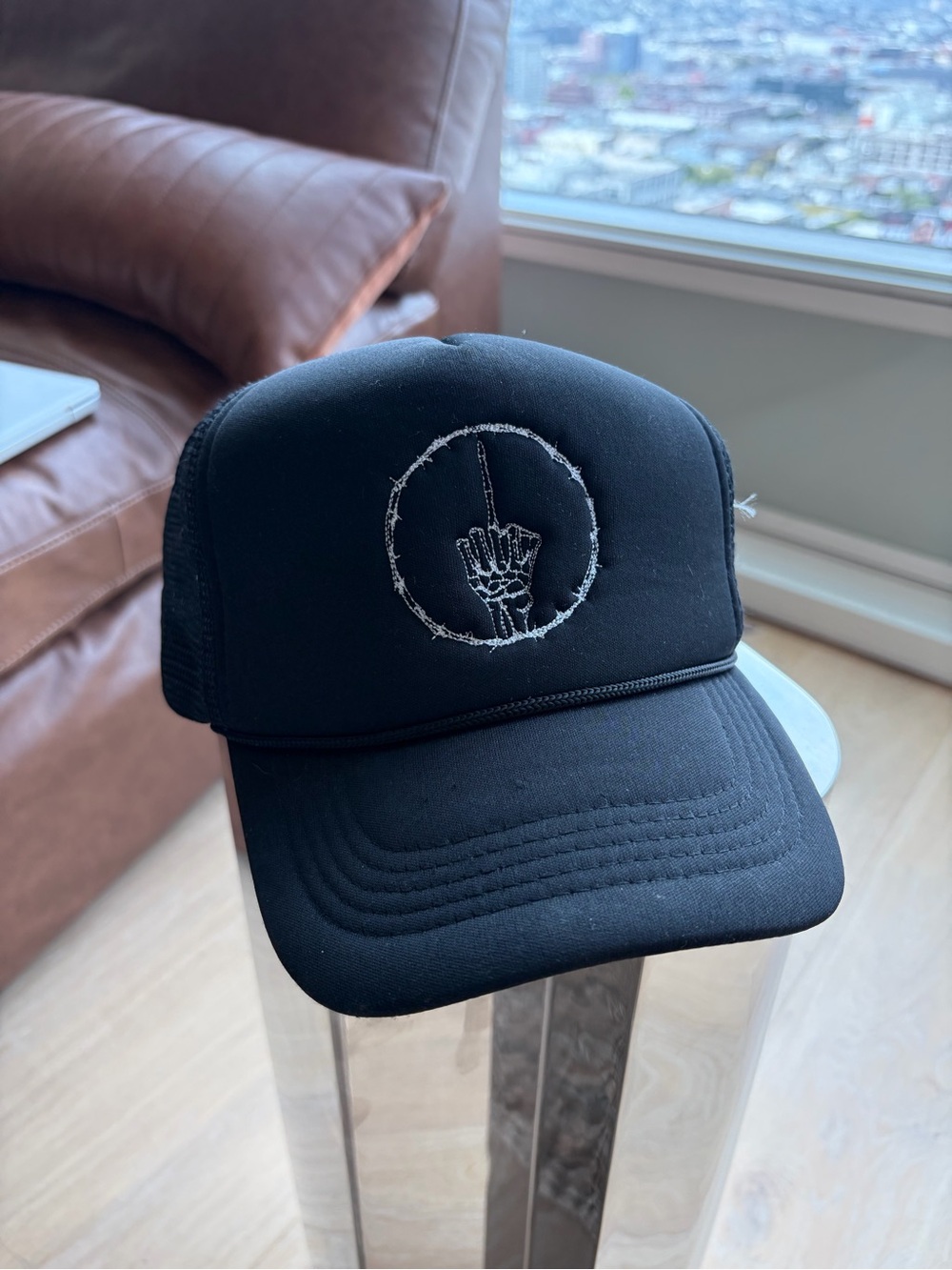 Black Trucker Hat with Embroidered Skeletal Middle Finger Design